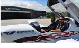 Two men sitting in the cockpit of a plane