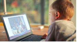 Boy sitting in front of a lap top