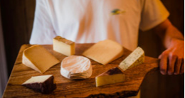 Man holding a cheese plate