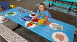 Girl sitting at a picnic table