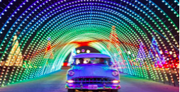 Car driving through a tunnel of lights