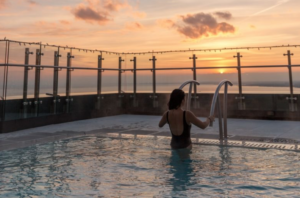 Girl getting out of a pool at sunset