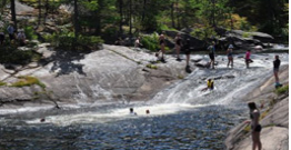 People sliding down a waterfall