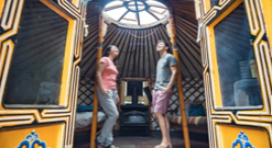 Two people standing in a yurt