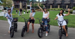 A group of girls on motorized bicycle's