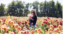 girl standing in a field of flowers