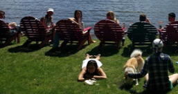 People sitting in chairs overlooking a lake