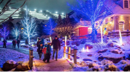 People walking over a bridge in winter with lights