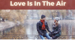 Two people sitting by water in winter