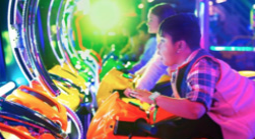 A boy playing an arcade game