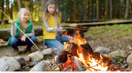 Kids sitting around a campfire