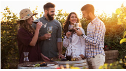 A group of people drinking wine outside