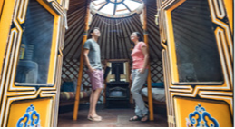 Two people standing inside a yurt