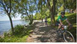 People biking on a path by the water