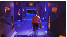 Man entering a hot tub