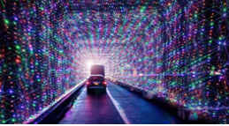Car driving through a tunnel of lights