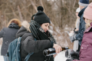 A girl pouring a glass of wine