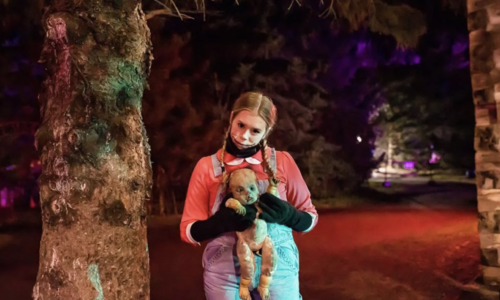 A scary girl holding a doll