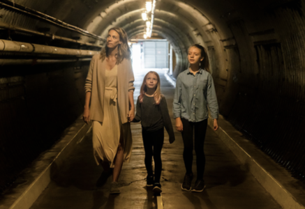 A women and children walking through a tunnel 