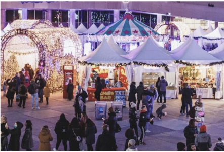 A crowd of people outside at a Christmas market