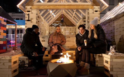 A group of people sitting around a fire