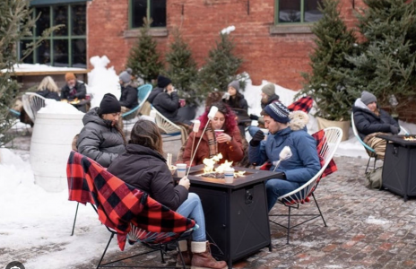 People sitting around a fire roasting marshmellos 