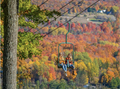 Two people on a chair lift during fall