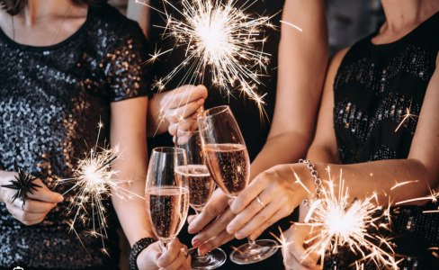 People holding champayne flutes and sparklers